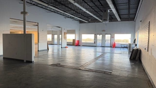 Open interior space looking toward the front entrance doors at 1883