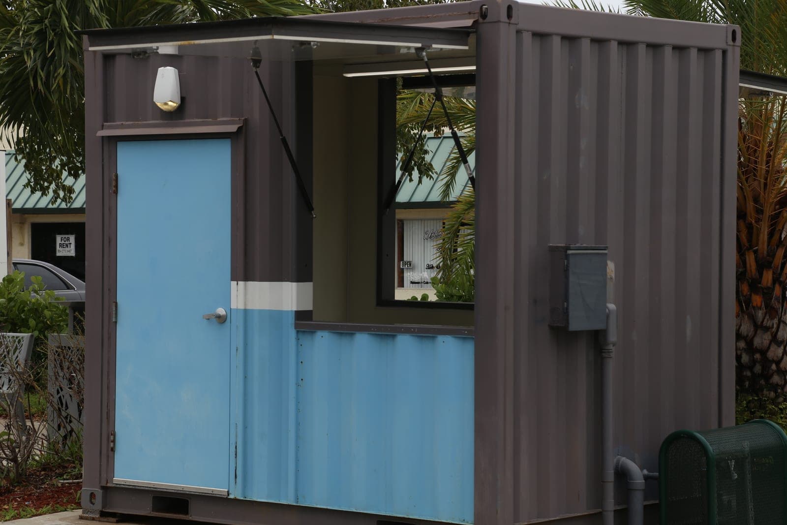 CRA kiosk exterior with door and open service window awning