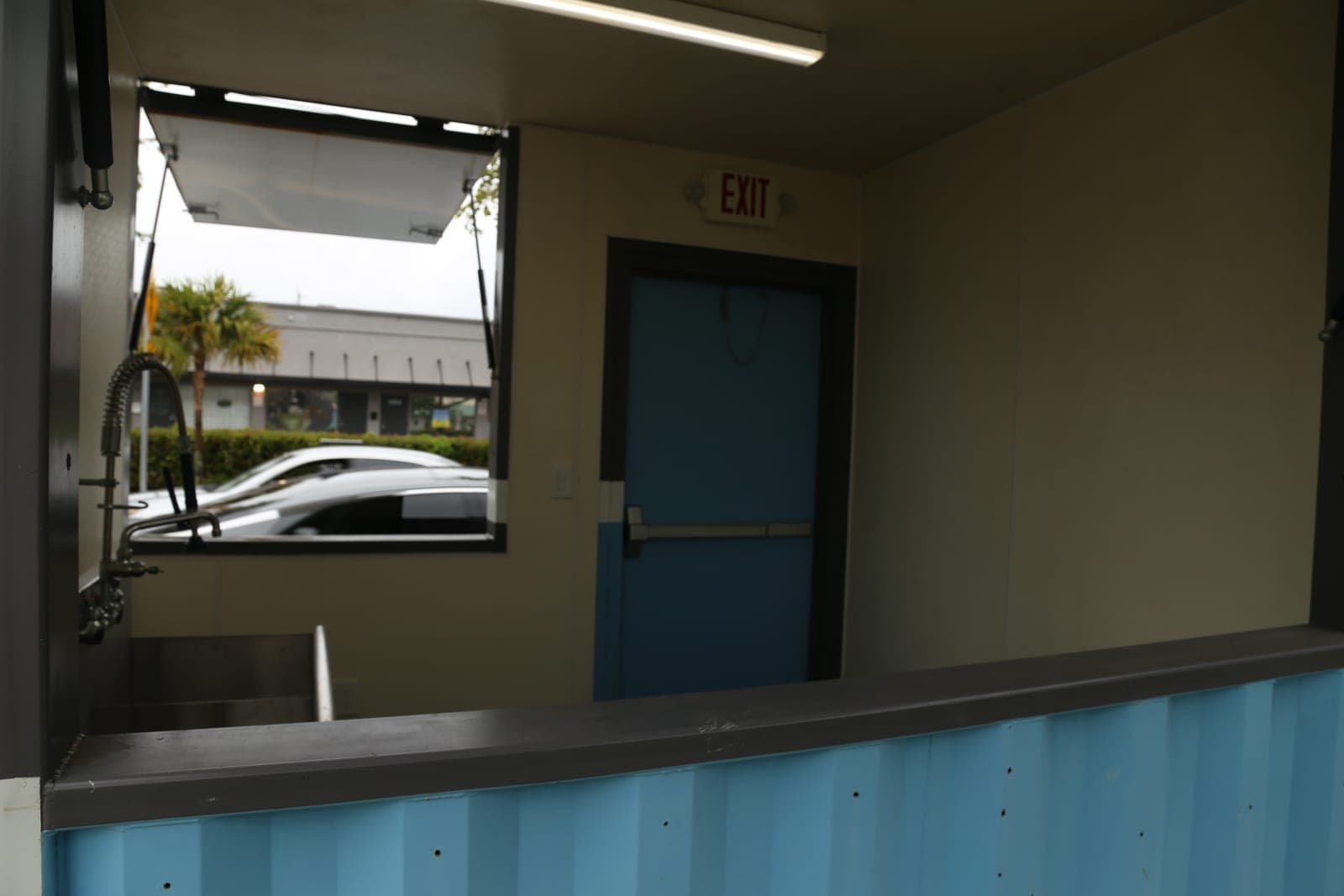 Inside a CRA kiosk showing the counter, service window, and sink
