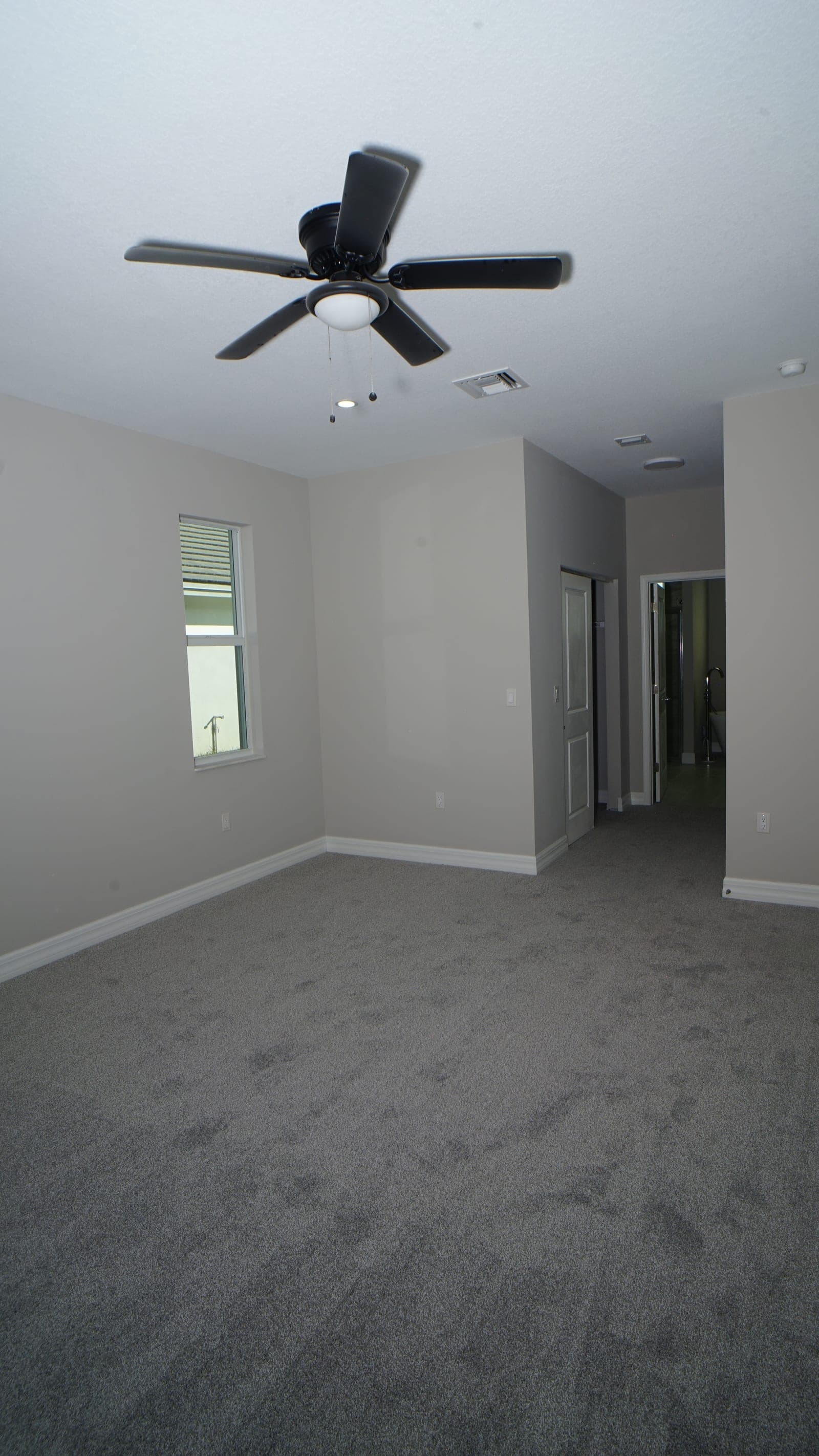 Interior bedroom with carpet and ceiling fan